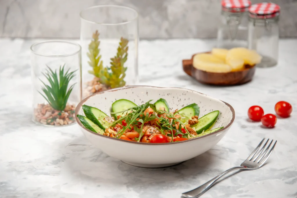 A fresh side salad topped with grilled chicken, one of the most healthy fast food options for a light meal.