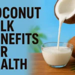 Coconut milk benefits for health shown with creamy coconut milk being poured into a glass bowl beside a fresh coconut, symbolizing natural nutrition and wellness.